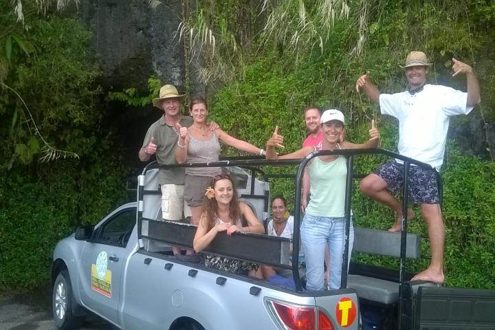 a group of people riding on the back of a truck